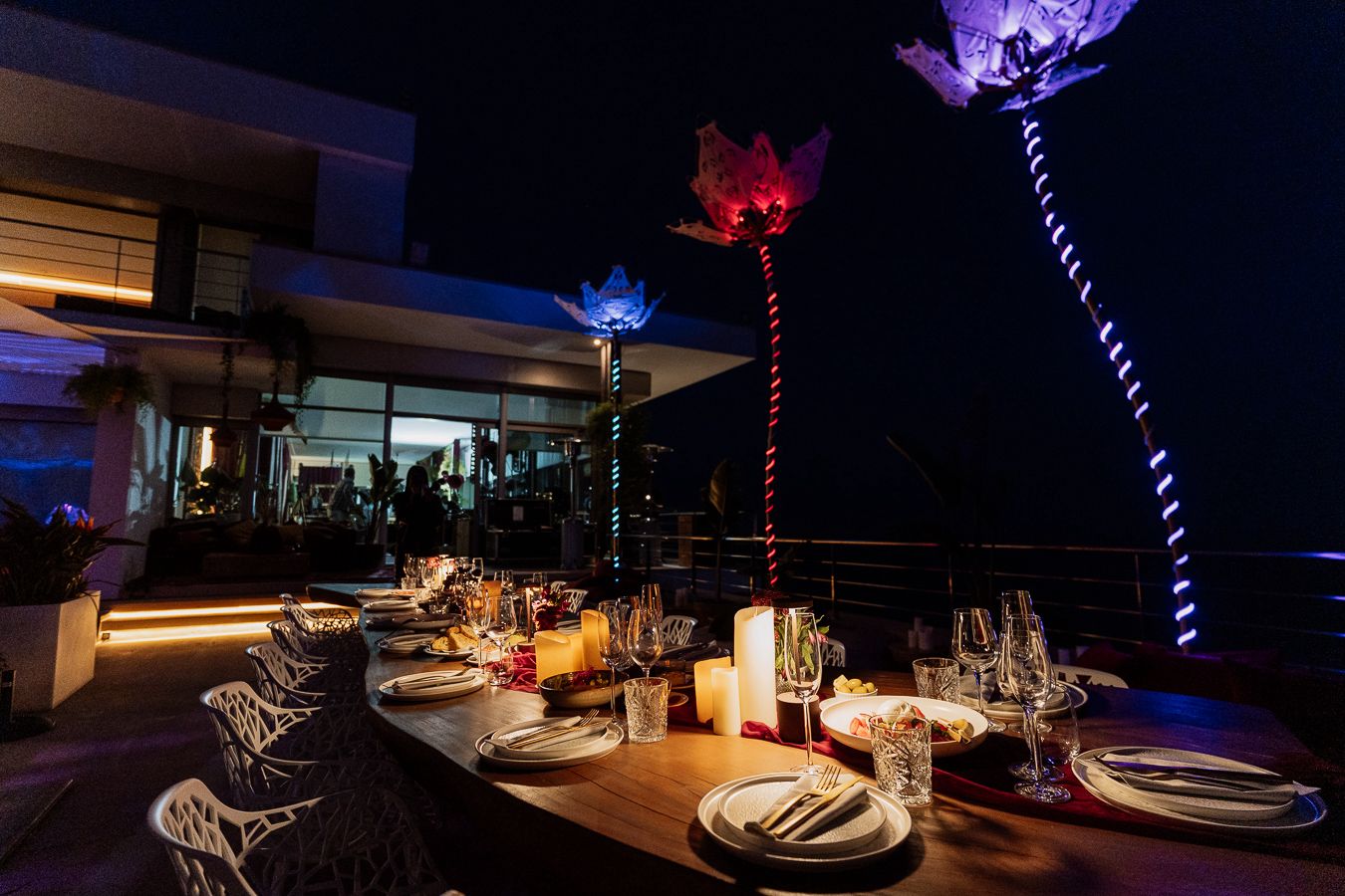 Candlelit destination dinner setting with illuminated flowers