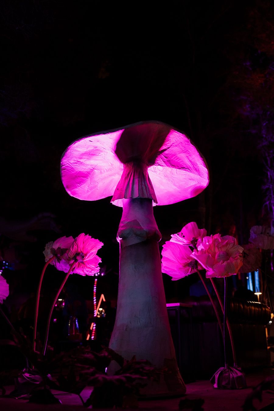 Illuminated sculptural mushroom installation at night